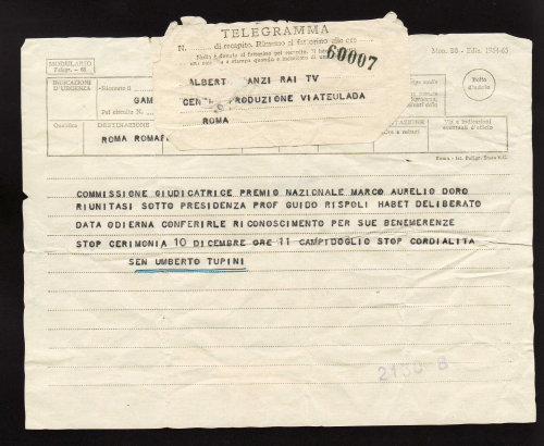 Telegramma: Alberto Manzi Rai TV Centro di produzione, via Teulada, Roma. Commissione giudicatrice premio nazionale Marco Aurelio Doro riunitasi sotto presidenza prof Guido Rispoli Habet deliberato data odierna conferirle riconoscimento per sue benemerenze stop. Cerimonia 10 dicembre ore 11 Campidoglio Stop. Cordialità Sen Umberto Tupini